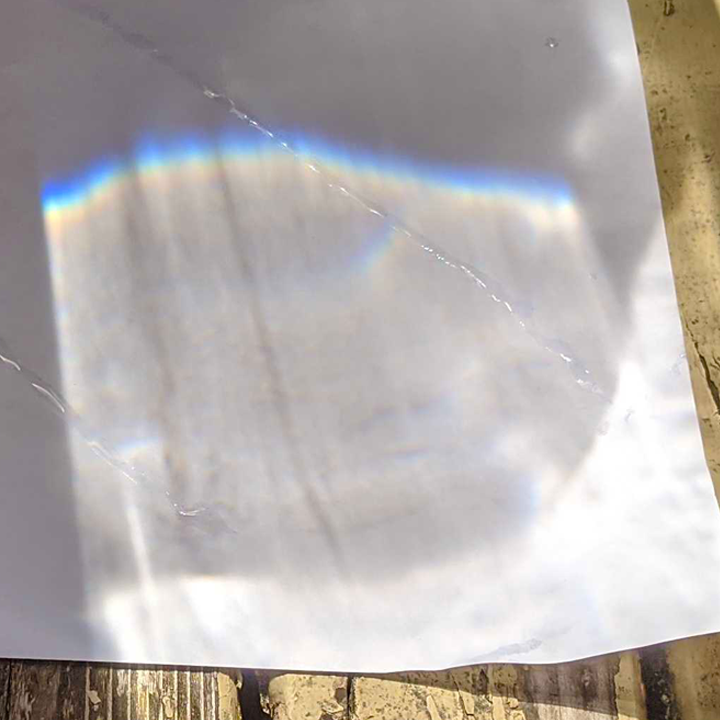 Rainbow science experiment created using a bucket of water and paper for light science - STEM Calendar For Educators: Month By Month STEM Projects