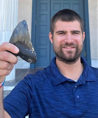 UC Riverside biologist and paper first author Phillip Sternes holding a Megalodon tooth. (Douglas Long/California Academy of Sciences) - Megalo-wrong? Megalodon Looked Vastly Different Than We Imagined