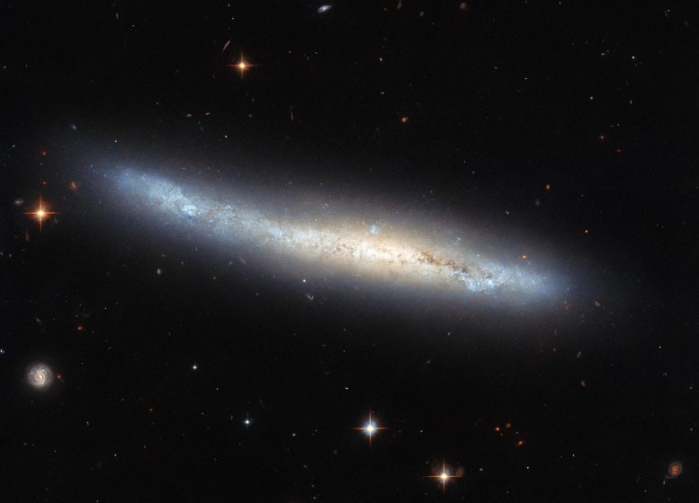 Galaxy NGC 4423 - Cosmic Illusions: Hubble Spots A Spiral Galaxy In Disguise