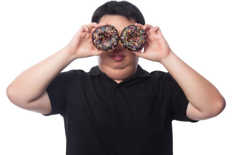 Man Holding Donuts Eyes - Eating Refined Carbs Reduces Your Facial Attractiveness – Regardless Of BMI Or Age