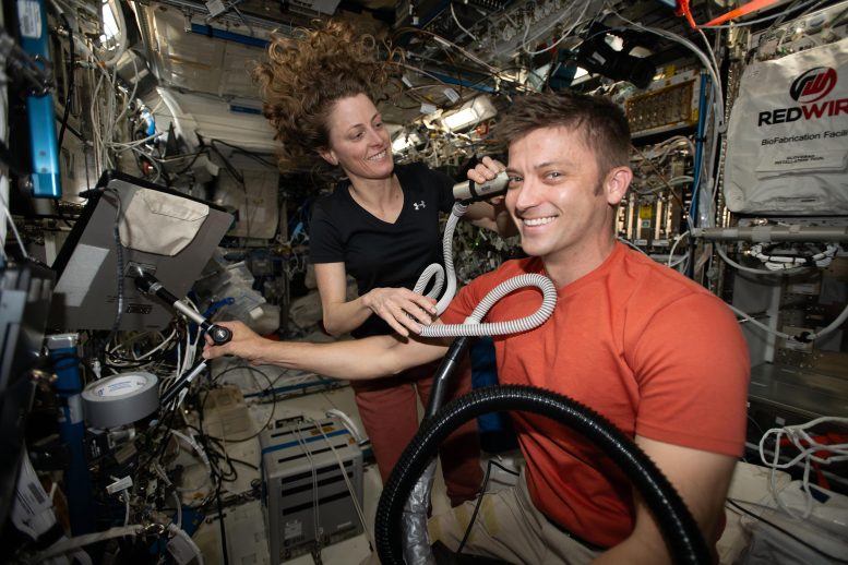 Astronaut Matthew Dominick Receives a Haircut From Astronaut Loral O’Hara - Tenfold Teamwork: ISS Crew Expansion Sparks Collaborative Science