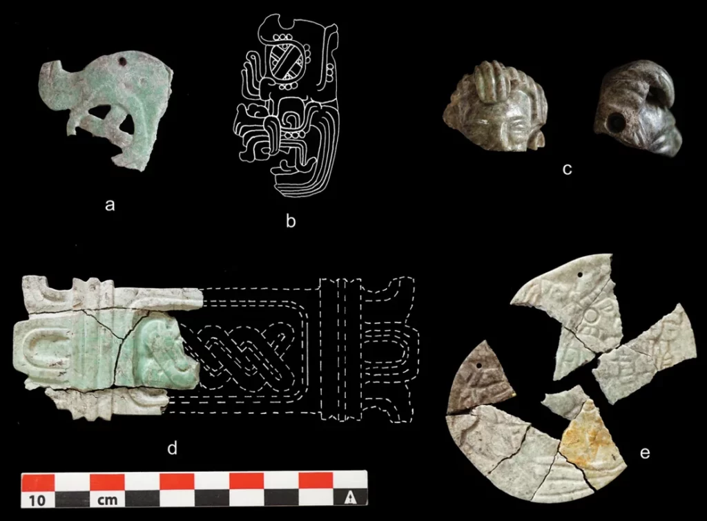 Burned and cracked greenstone ornaments. - Burned Remains At Maya Pyramid Reveal Dramatic Regime Change